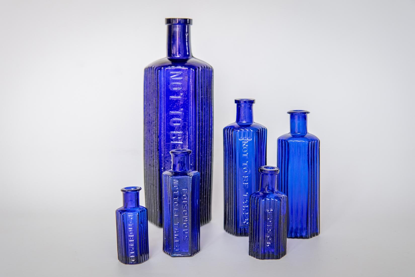 Antique glass cobalt blue collection of octagonal poison bottles - Natalia Willmott