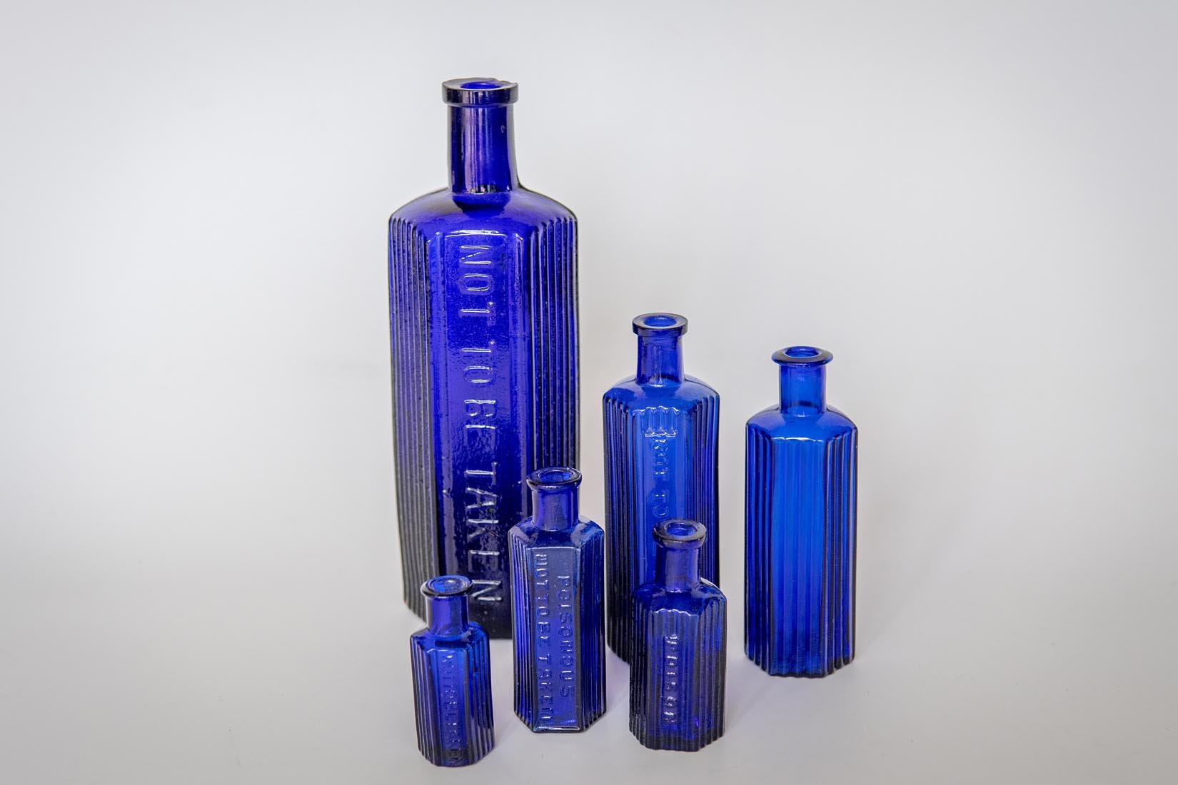 Antique glass cobalt blue collection of octagonal poison bottles - Natalia Willmott