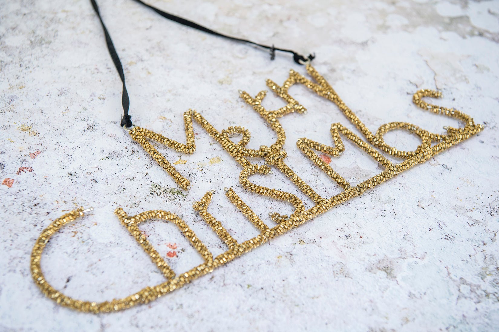 Beaded Merry Christmas sign in gold - Natalia Willmott