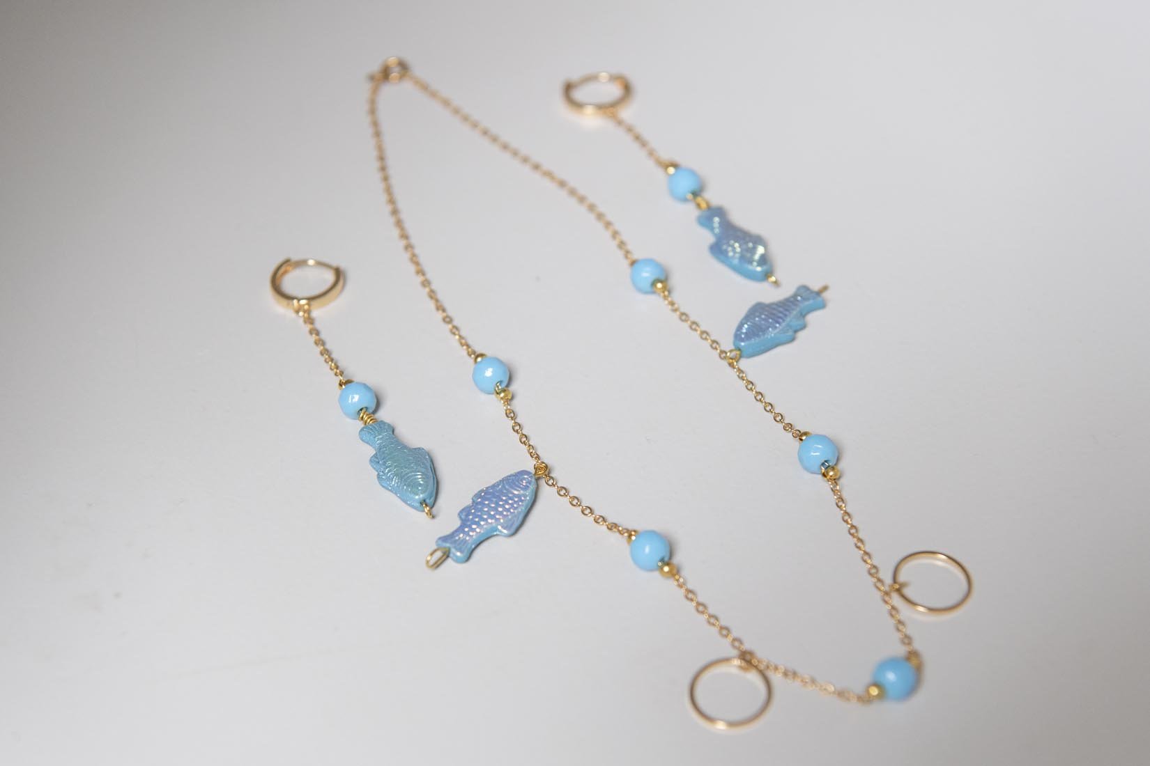 Iridescent blue fish gold plated earrings or necklace - Natalia Willmott