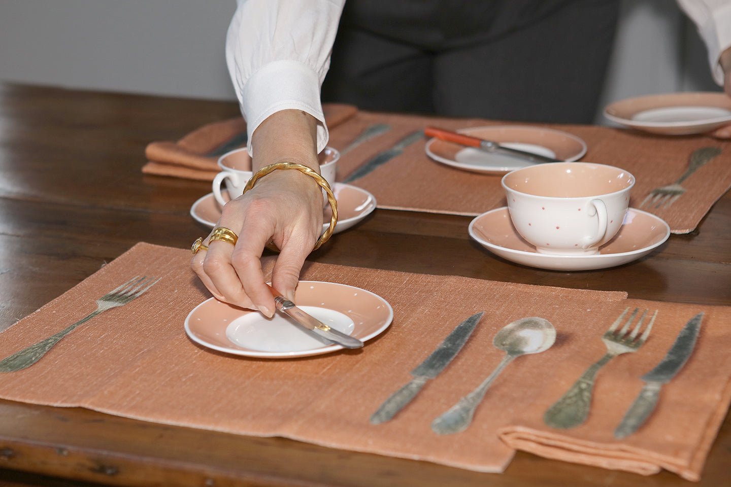 Pair of napkins and Pair of place mats printed with image of antique spoon, fork and knife - Natalia Willmott