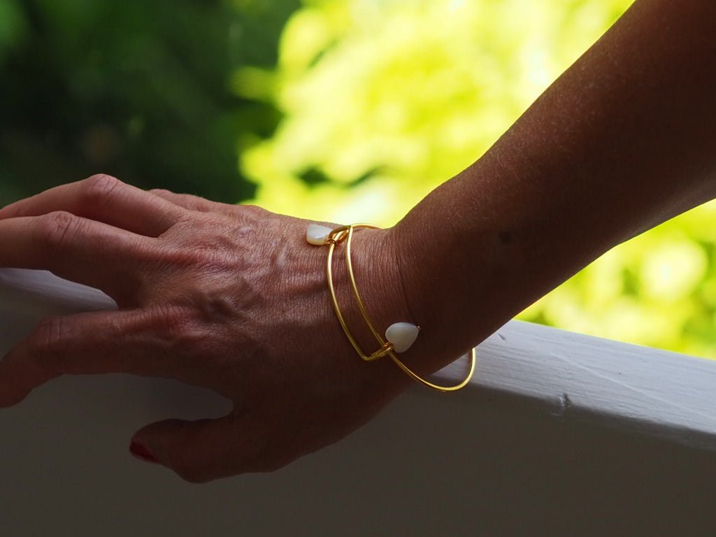 Gold plated bangle with two mother of pearl hearts - Natalia Willmott