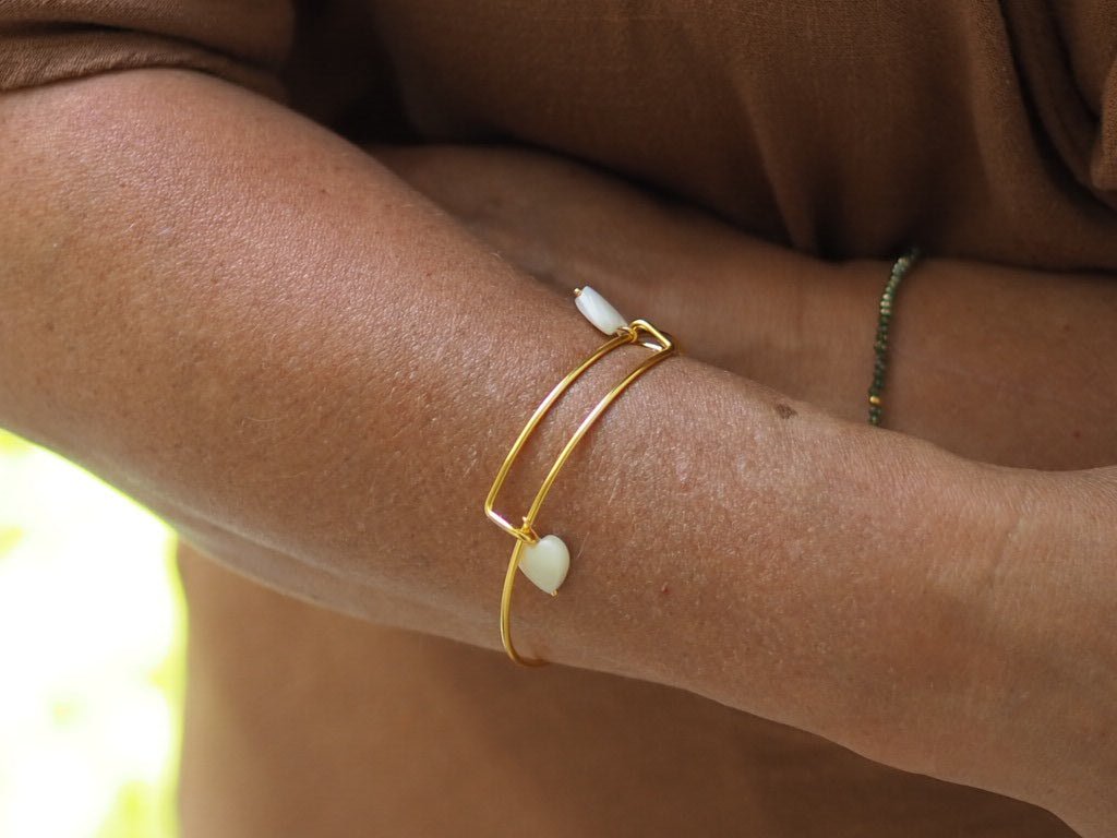 Gold plated bangle with two mother of pearl hearts - Natalia Willmott