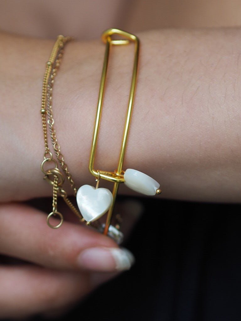 Gold plated bangle with two mother of pearl hearts - Natalia Willmott