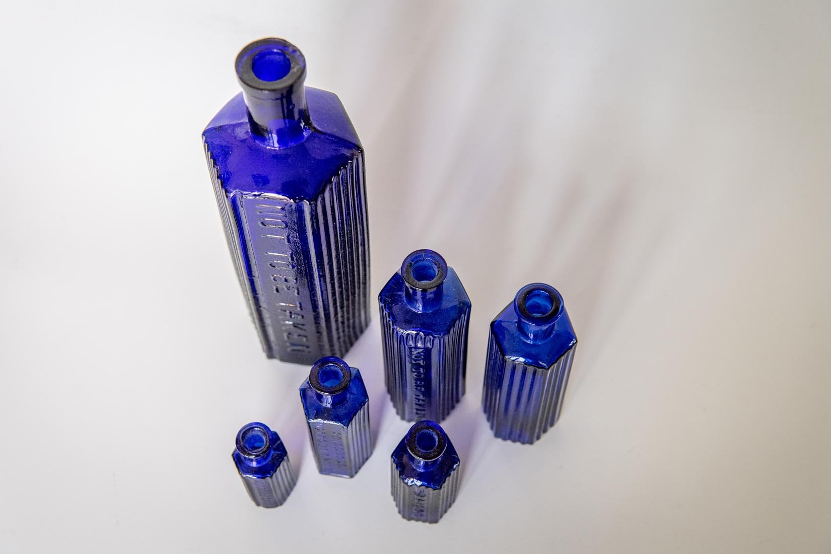 Antique glass cobalt blue collection of octagonal poison bottles - Natalia Willmott